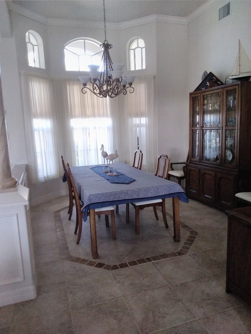 Dining Room with Bowed Windows and Decorative Tile