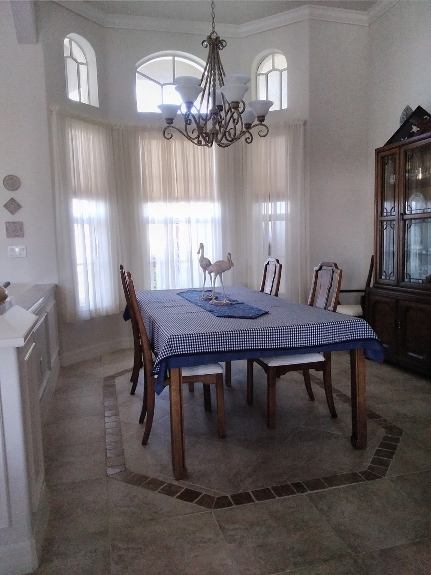 Dining Room with Bowed Windows and Decorative Floor Tile
